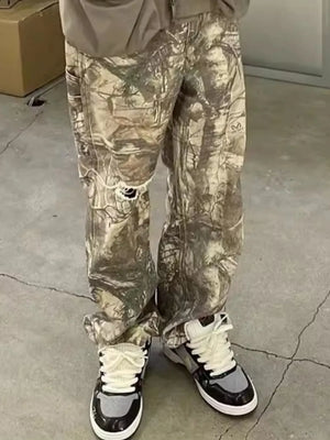 Distressed camo carpenter jeans in gray with ripped knees and a relaxed fit.