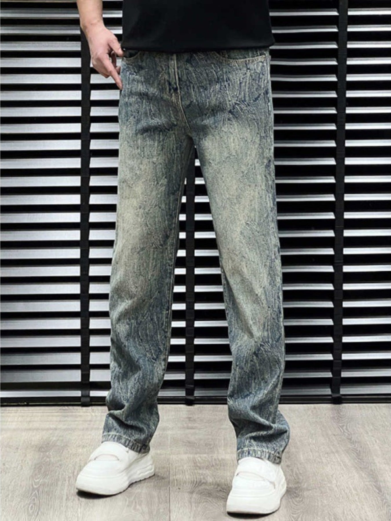 Men's relaxed fit jeans in vintage wash blue cotton with distressed details.