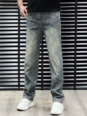 Men's relaxed fit jeans in vintage wash blue cotton with distressed details.