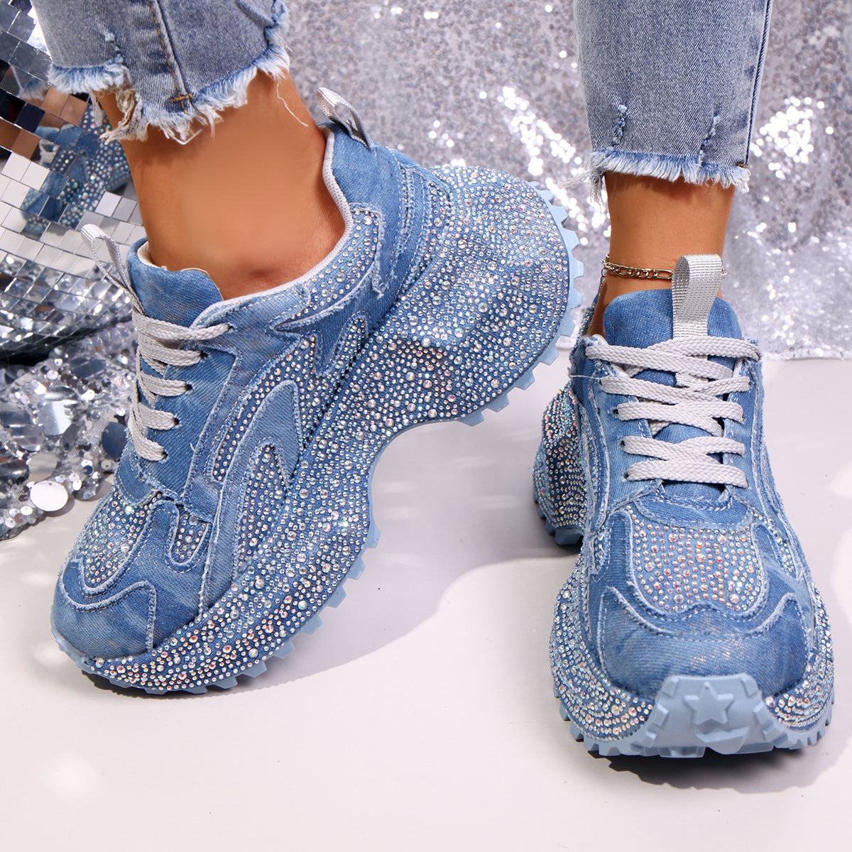 Blue rhinestone high-heel platform sneakers with lace-up closure and chunky sole.