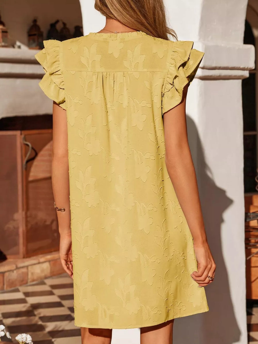 Apricot floral embossed mini dress with ruffled sleeves and button detail.