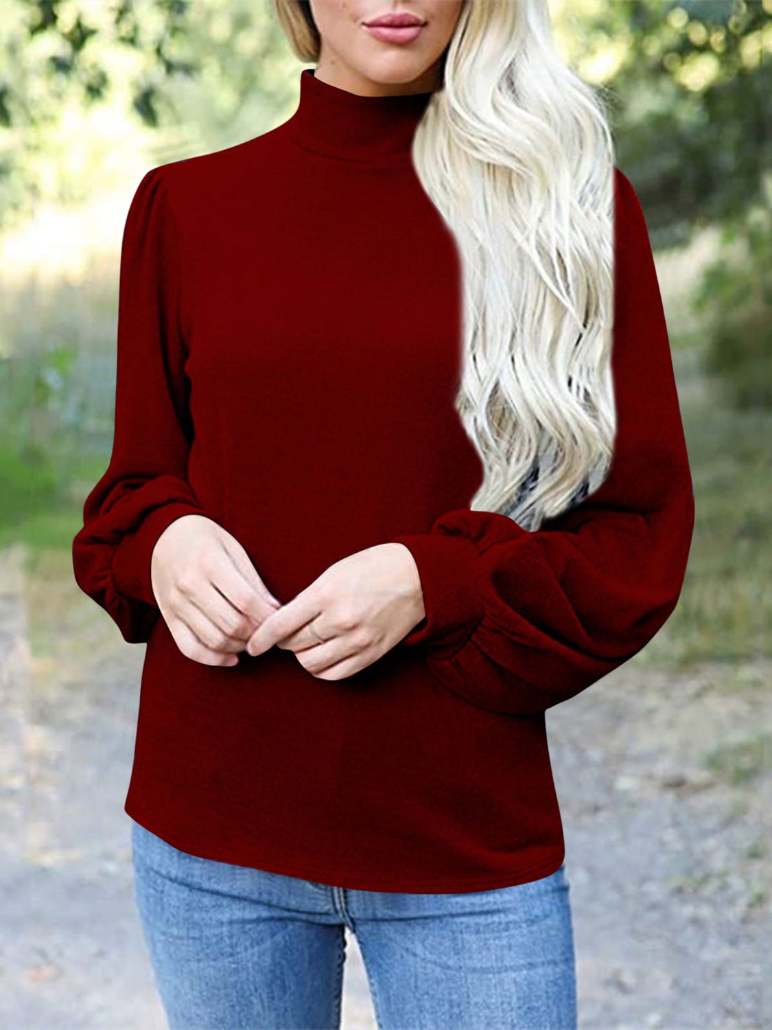 Burgundy mock neck top with puff sleeves and button back detail.