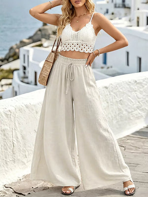 Wide leg linen pants in beige with drawstring waist, paired with a white crochet crop top.