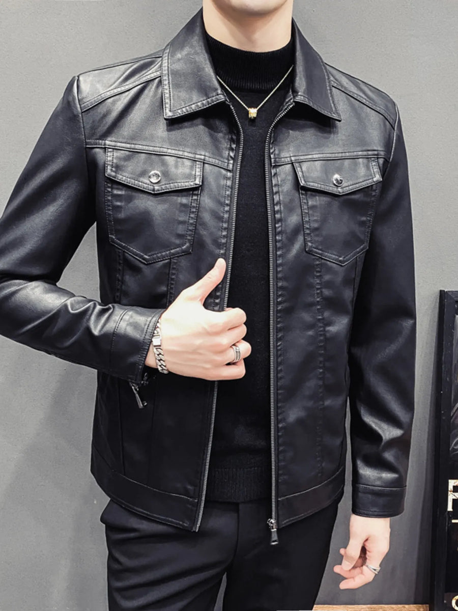 Men's black faux leather trucker jacket with chest pockets and zip closure.