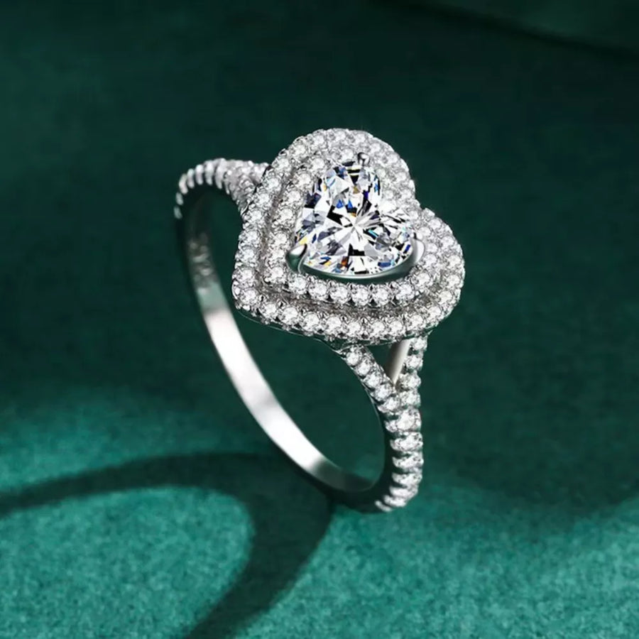 Silver ring with heart-shaped moissanite and double halo of small diamonds.