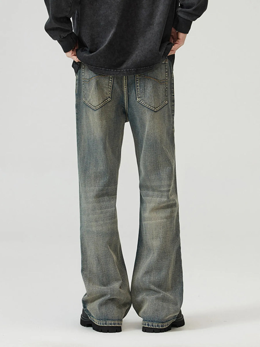 Vintage wash denim jeans with a wide-leg cut and distressed details.