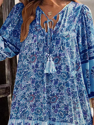Light Blue floral print mini dress with tassel tie neckline and bell sleeves.