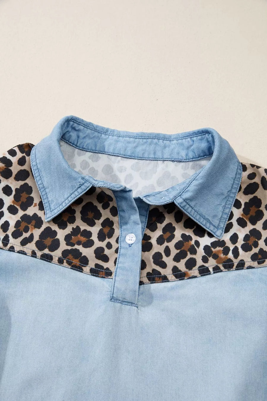 Denim polo shirt with leopard print yoke and collar, button front.