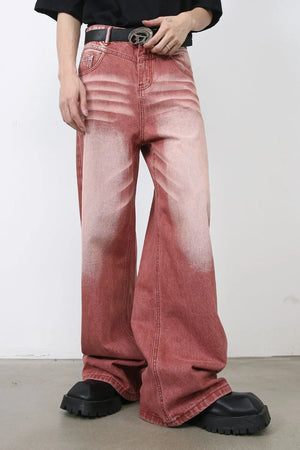 Dip-dye wide-leg denim trousers in rust with a faded effect, styled with chunky black shoes.