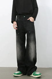 Faded wash wide-leg carpenter jeans in dark black with green button detail.