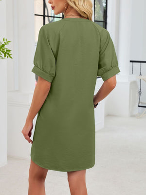 Army green cotton dress with short sleeves, notched V-neck, and tie waist detail.