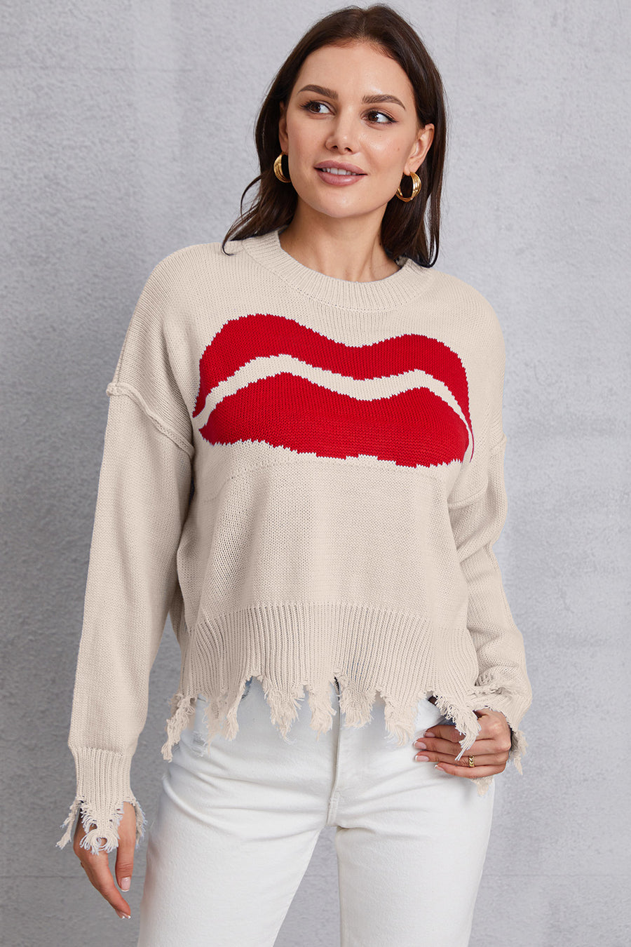 Cream knit sweater with red kiss graphic, distressed hem and cuffs.