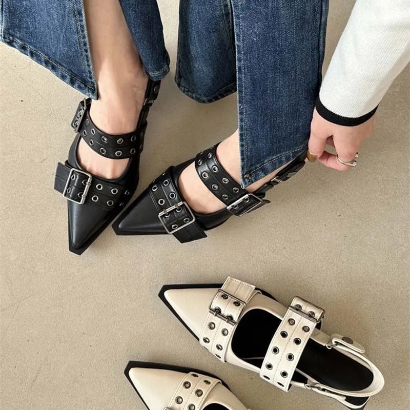 Black studded pointed-toe slingback flats with double buckle straps