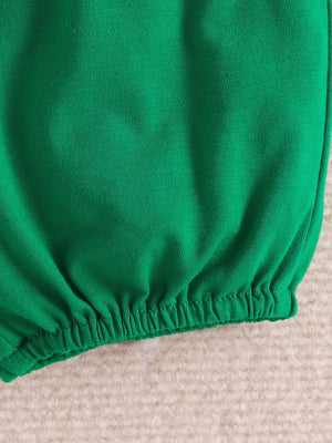 Green baby polo and shorts set with dinosaur print, elastic waistband detail