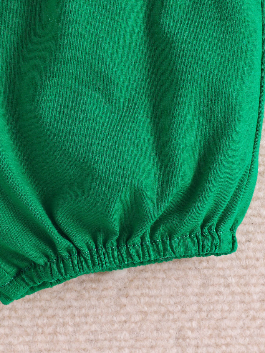 Green baby polo and shorts set with dinosaur print, elastic waistband detail