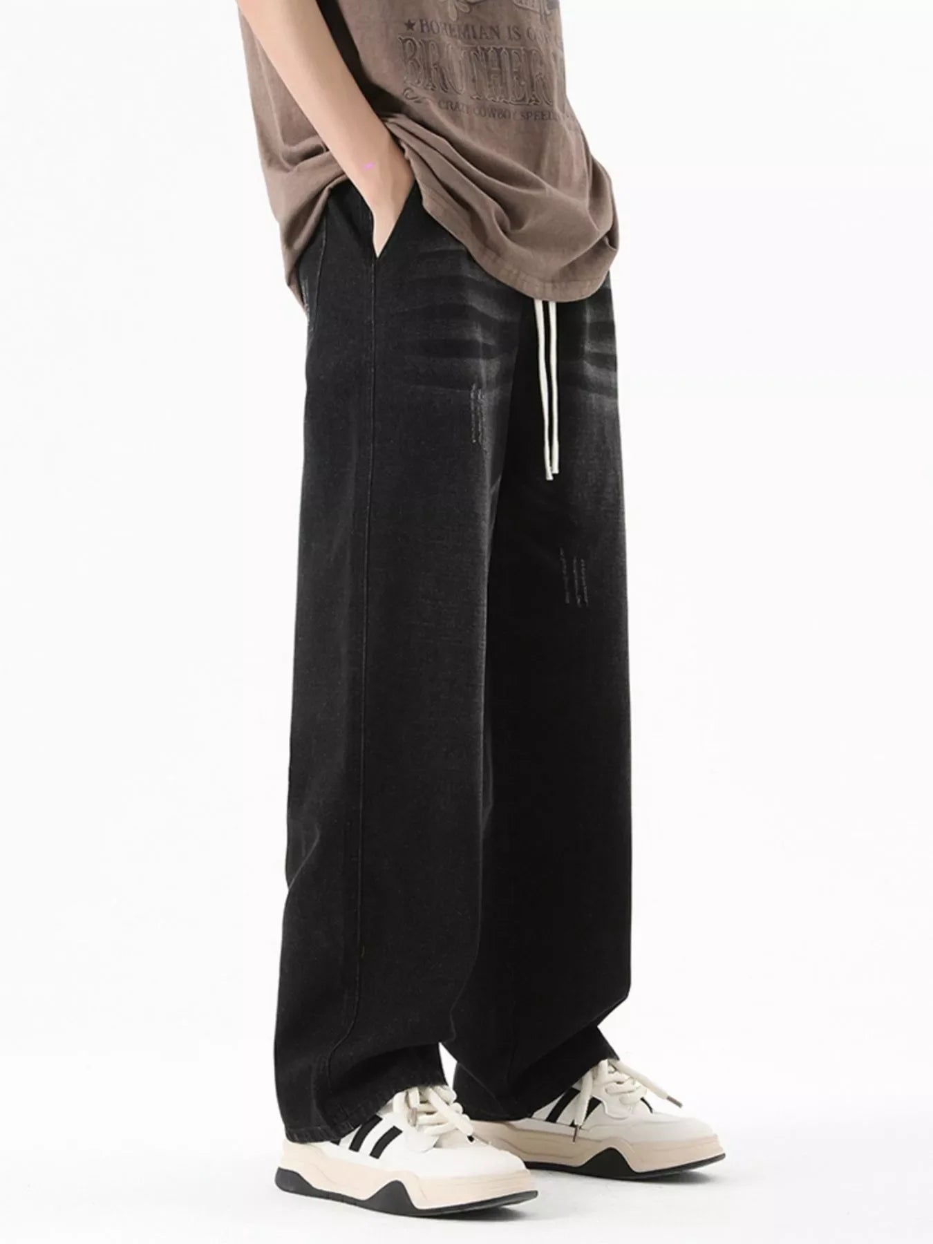 Black gray wide-leg jeans with drawstring and distressed details.
