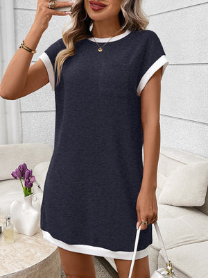 Navy ribbed knit mini dress with white trim, crew neck, short sleeves and a chest pocket.