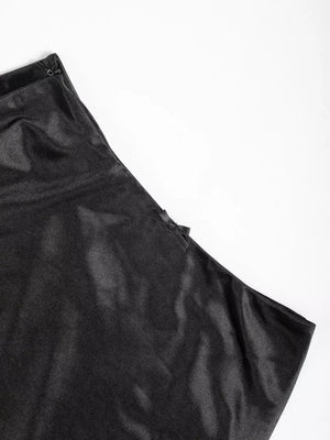 Black satin high-waisted skirt with a subtle bow detail and zipper closure.