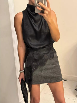 Asymmetrical black cami top with lace trim detail and cowl neck.