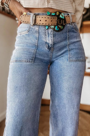 Light wash denim wide leg jeans with patch pockets and a western-style turquoise belt.