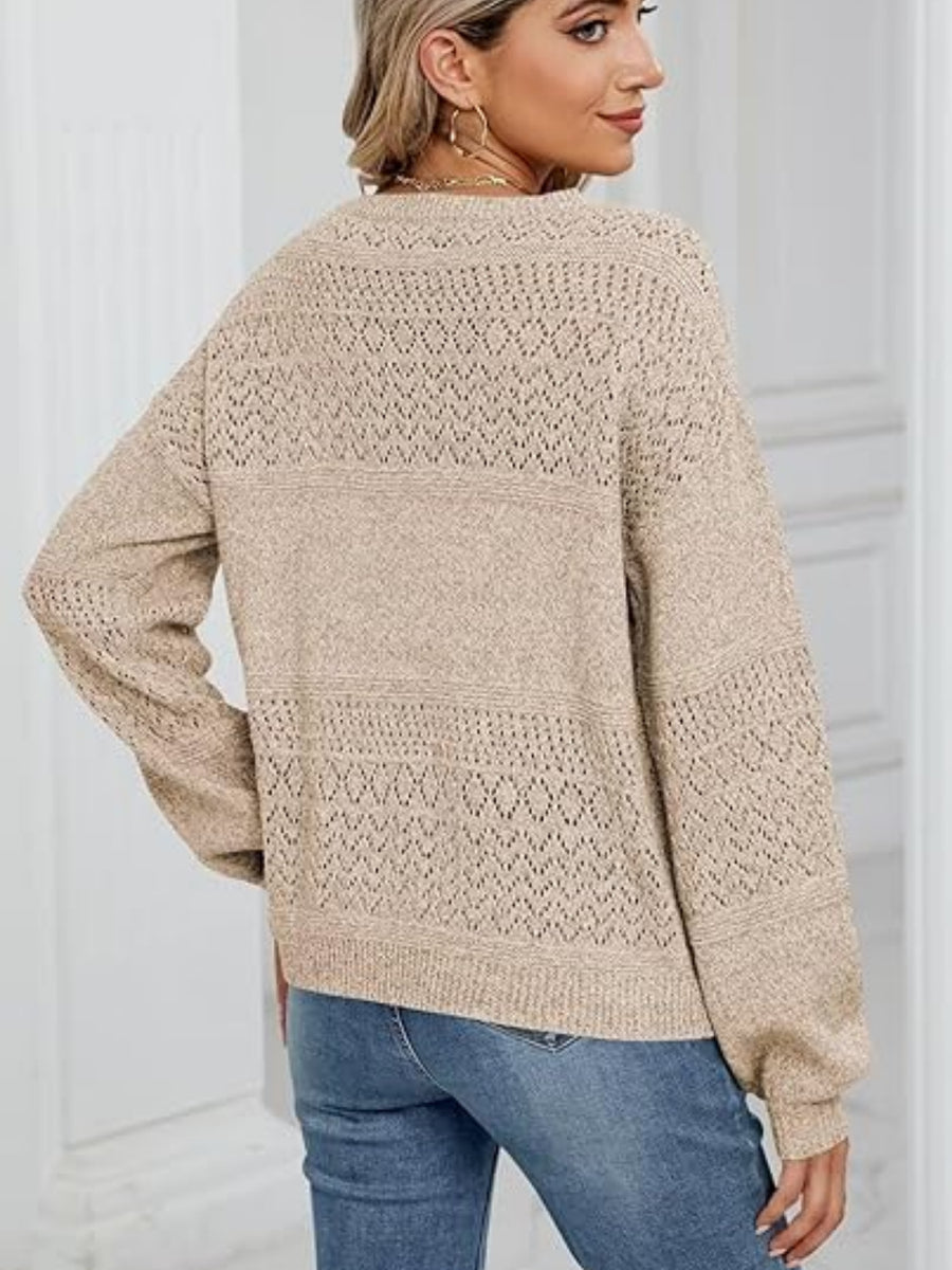 Tan eyelet stitch v-neck pullover sweater with long sleeves.