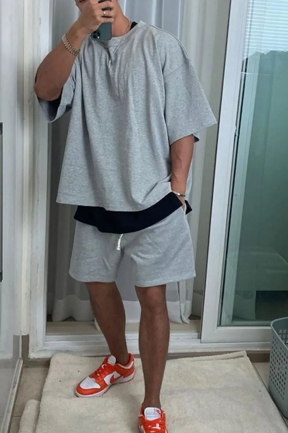 Gray oversized drop-shoulder tee with black undershirt and matching shorts.