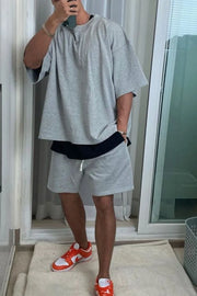 Gray oversized drop-shoulder tee with black undershirt and matching shorts.