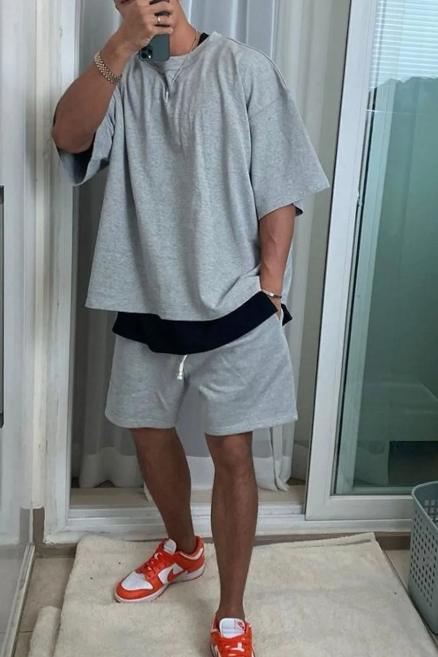 Gray oversized drop-shoulder tee with black undershirt and matching shorts.