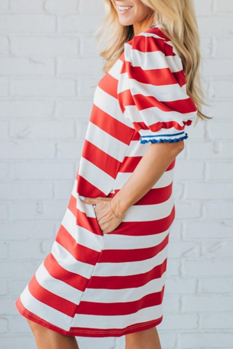 Red and white striped cotton mini dress with puff sleeves and blue trim.