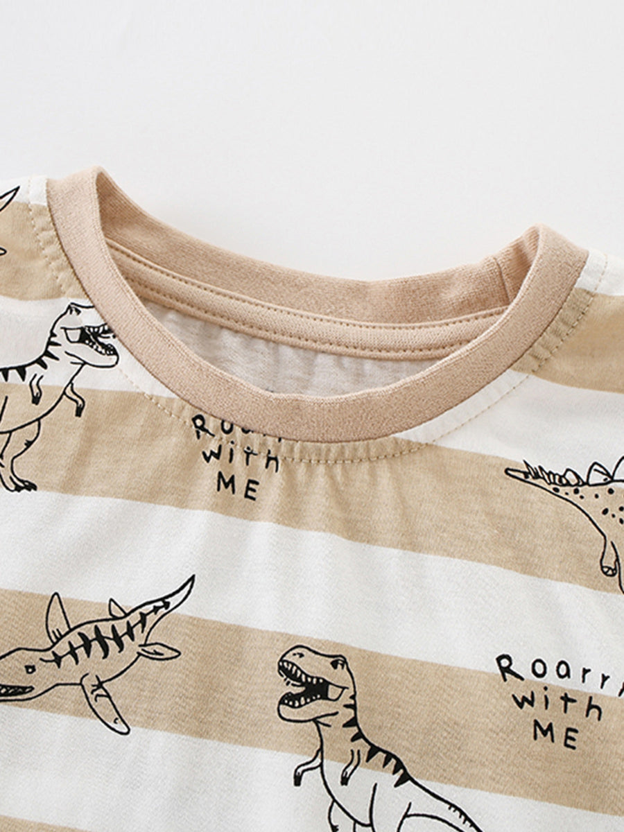 Toddler t-shirt with beige and white stripes, dinosaur print, and text detail.
