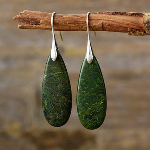 Silver teardrop dangle earrings with green stone grain texture
