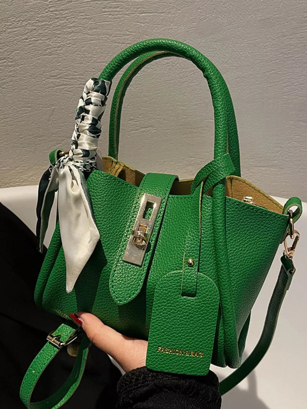 Green crossbody bag with scarf detail on handle and gold hardware