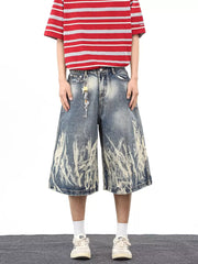 Men's wide-leg denim shorts with abstract bleach wash and pockets