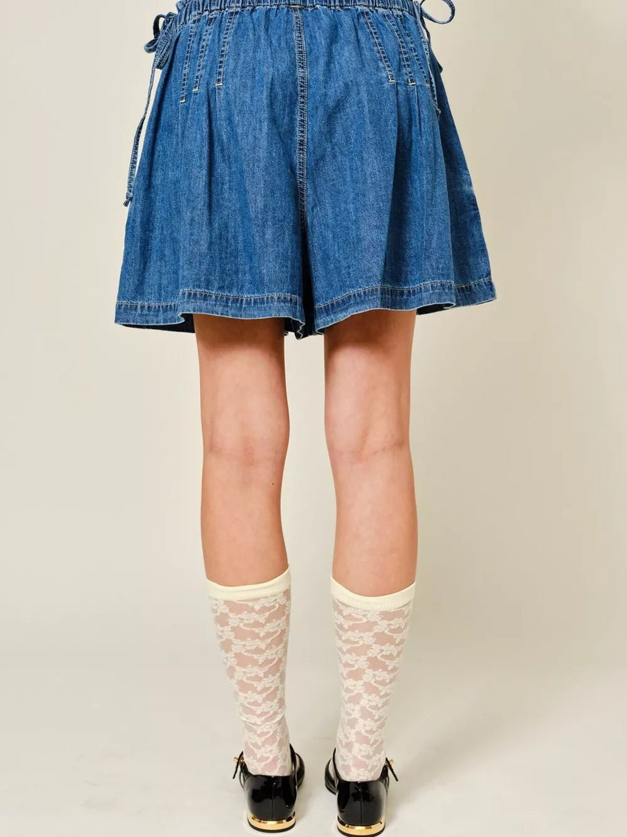 Dark blue denim-effect shorts with ruched waist and tie detail.