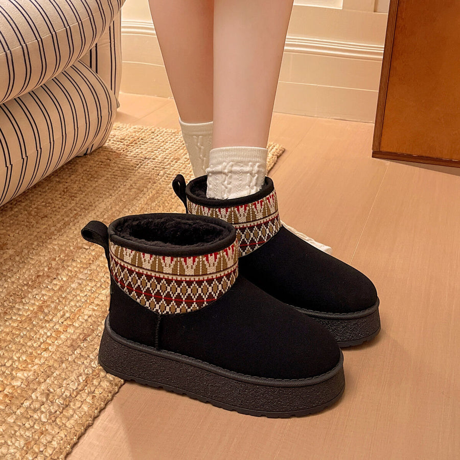 black boots featuring platform sole and geometric