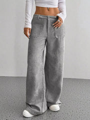 Grey corduroy wide-leg trousers with front pockets and a comfortable fit.