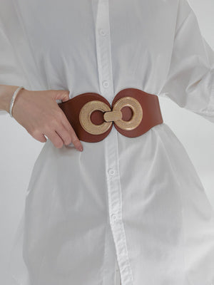 Caramel elastic waist belt with gold metalwork detail cinches a white shirt.