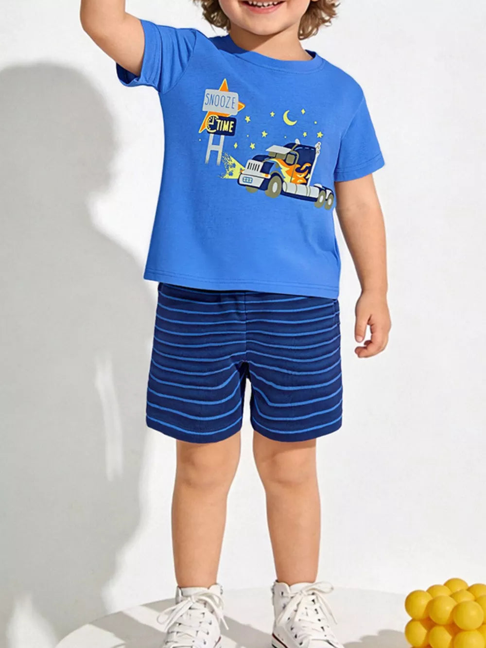 Blue cotton toddler pajama set with truck graphic tee and striped shorts