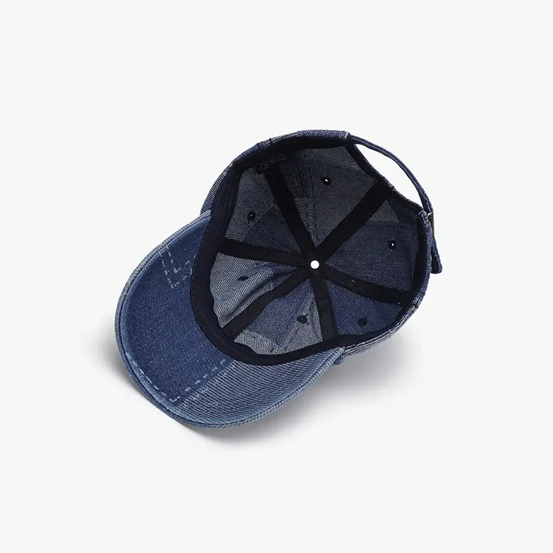 Denim patchwork baseball cap in medium blue with adjustable strap and stitched details.