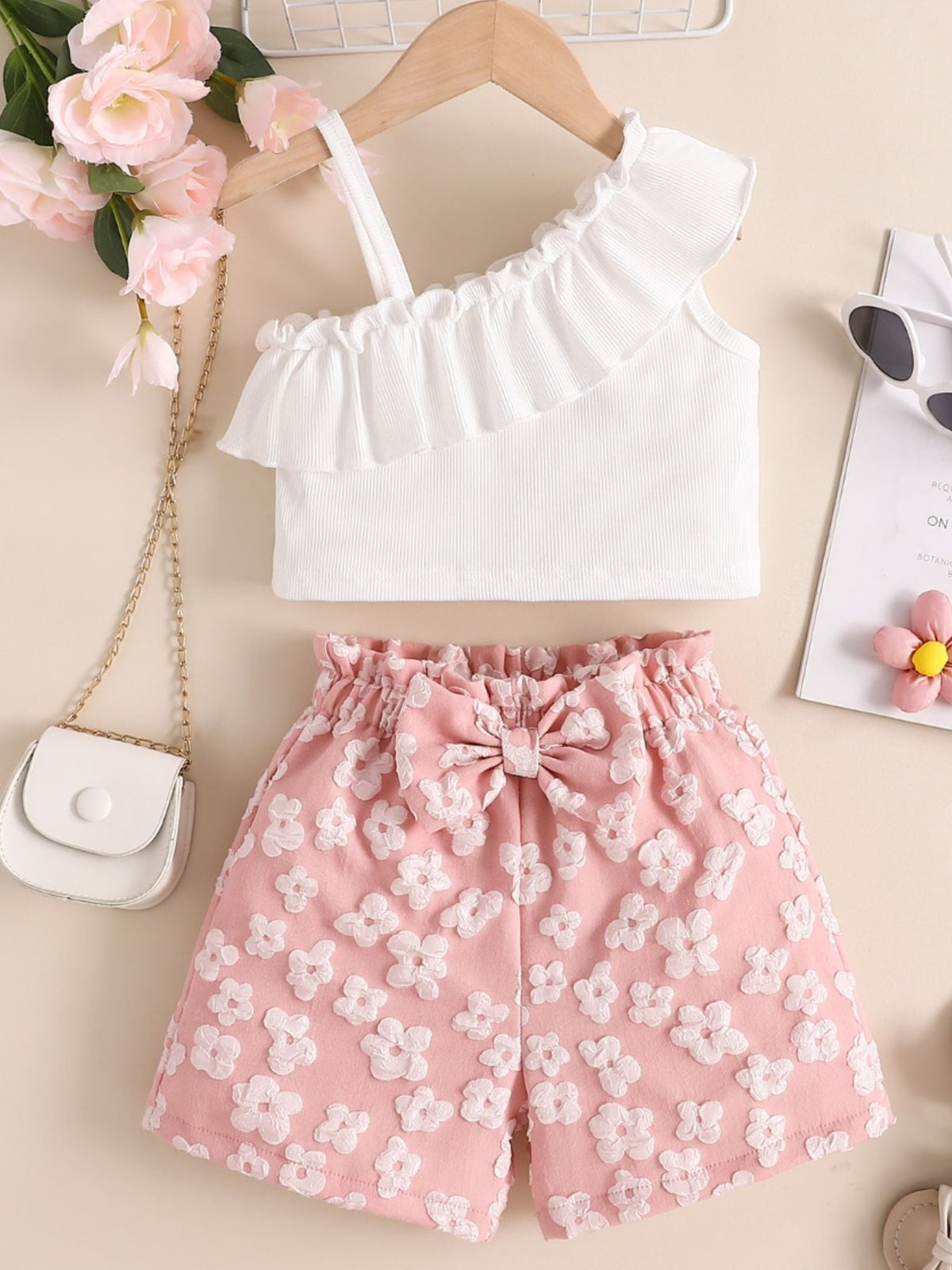 White asymmetrical ruffled top and pink floral shorts set with bow detail