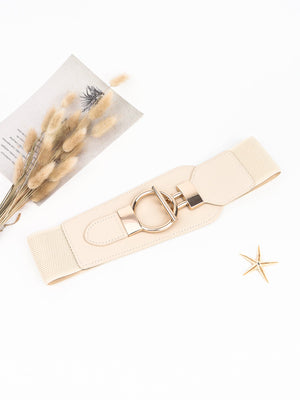 Cream elastic belt with sculpted gold hardware buckle