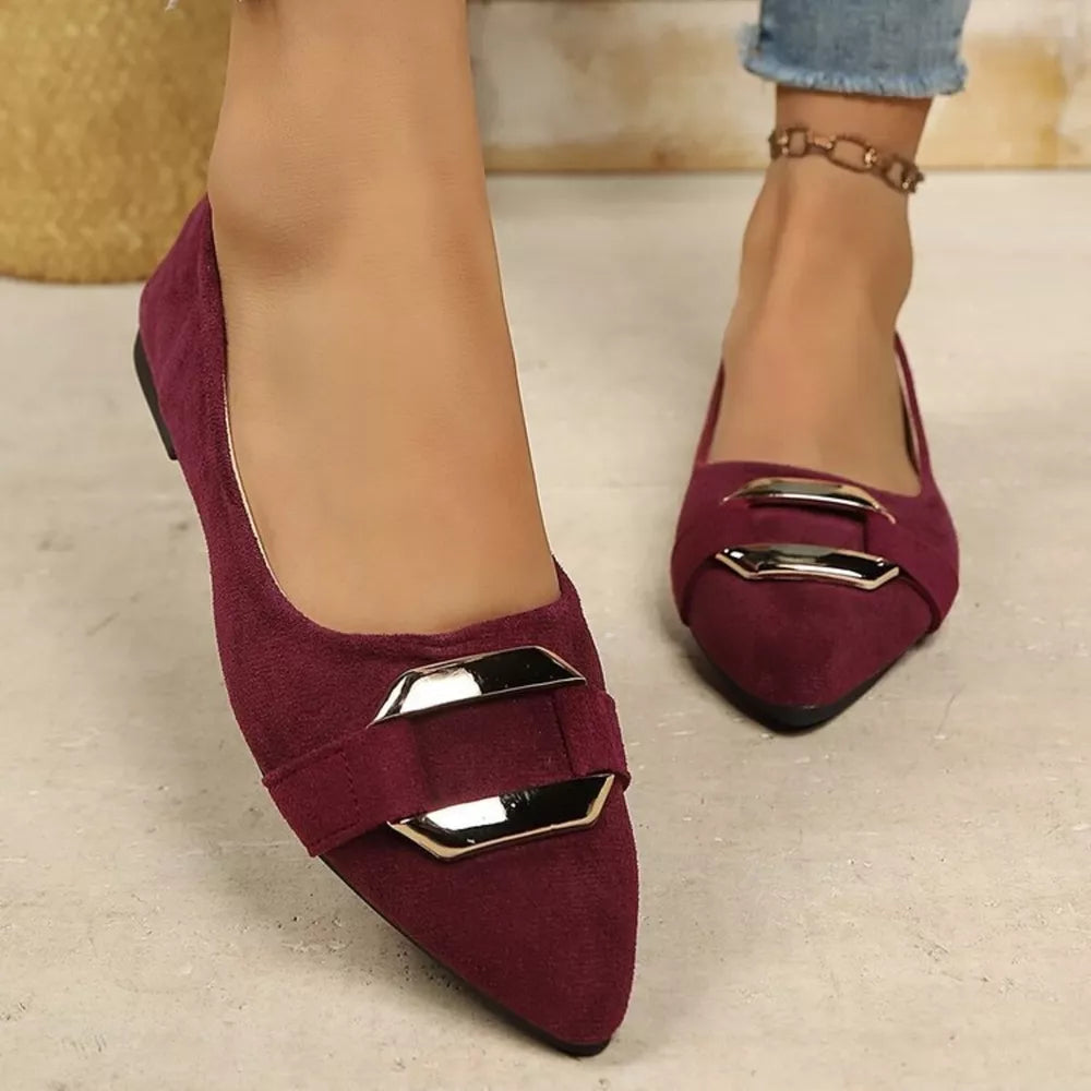 Red pointed-toe slip-on flats with double buckle detail.
