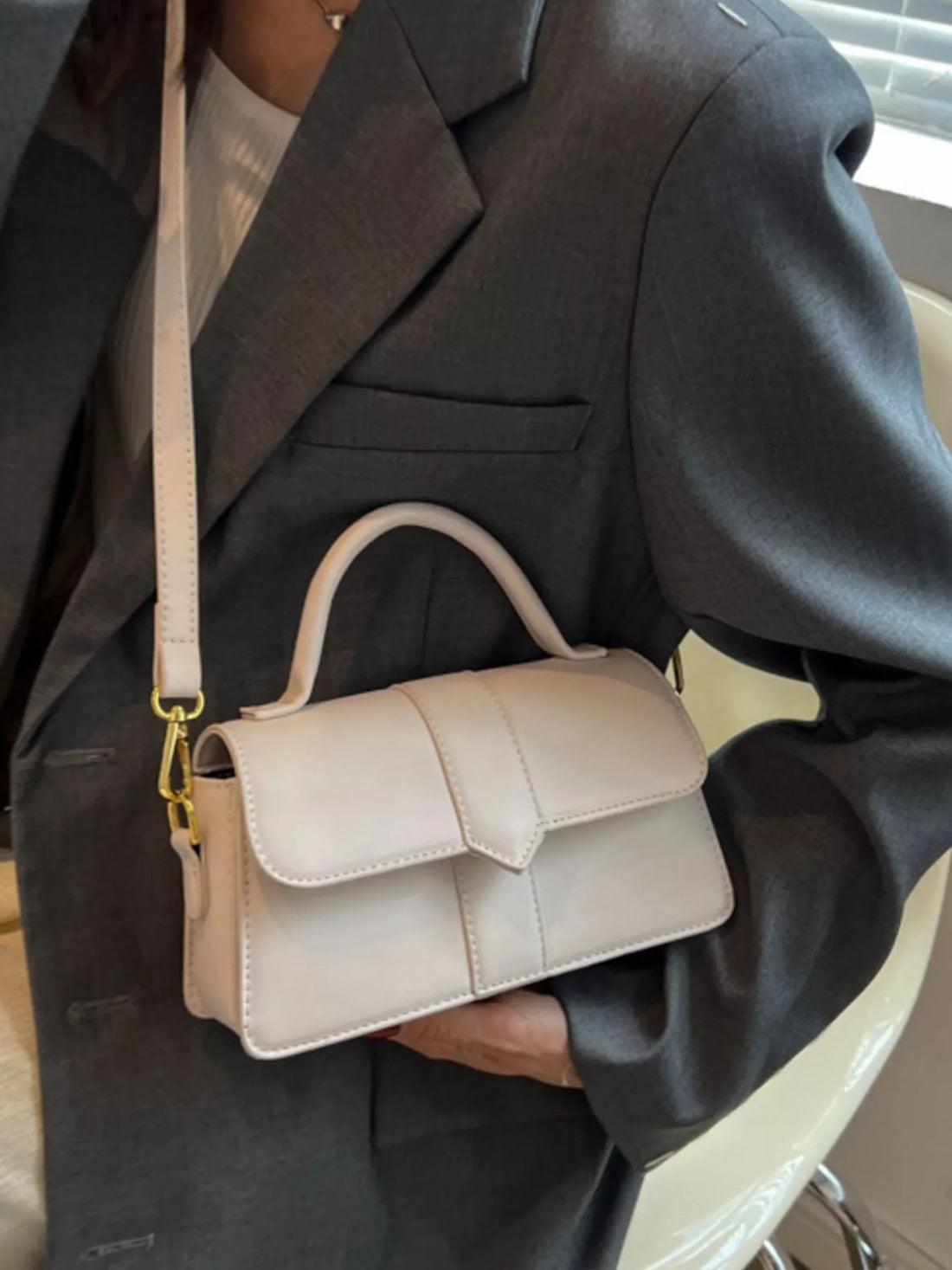 Chic small top handle shoulder bag in Rice White with a flap closure and top handle.