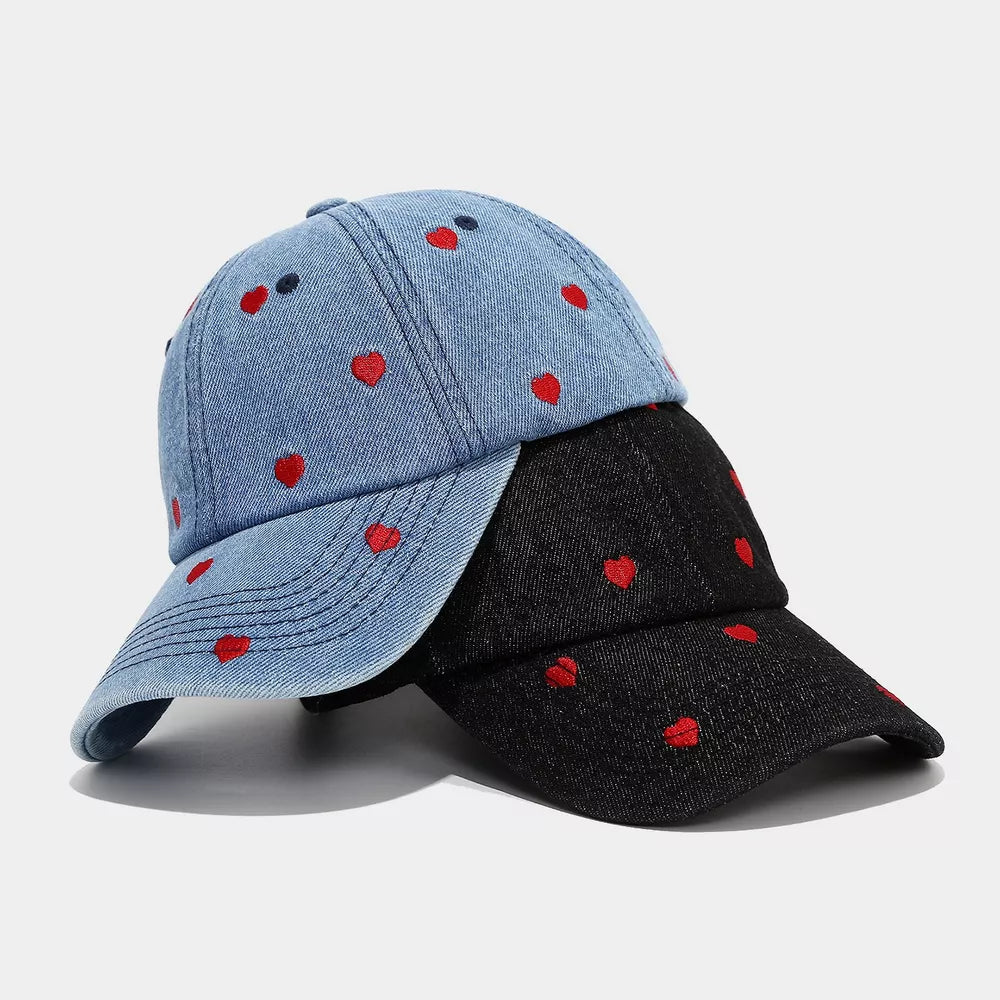 white cap featuring embroidered and heart