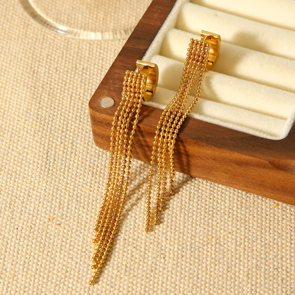 earrings in gold featuring tassel and dangle fit