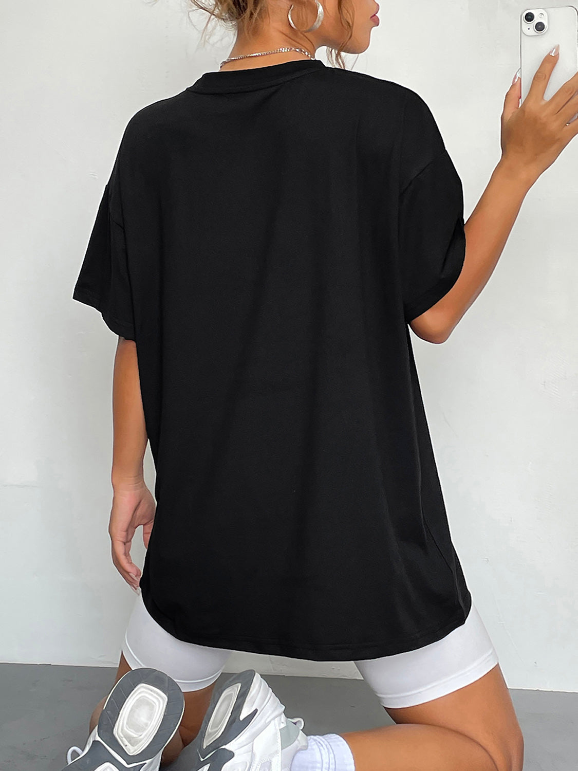 Black crew neck graphic t-shirt with short sleeves and a relaxed fit.