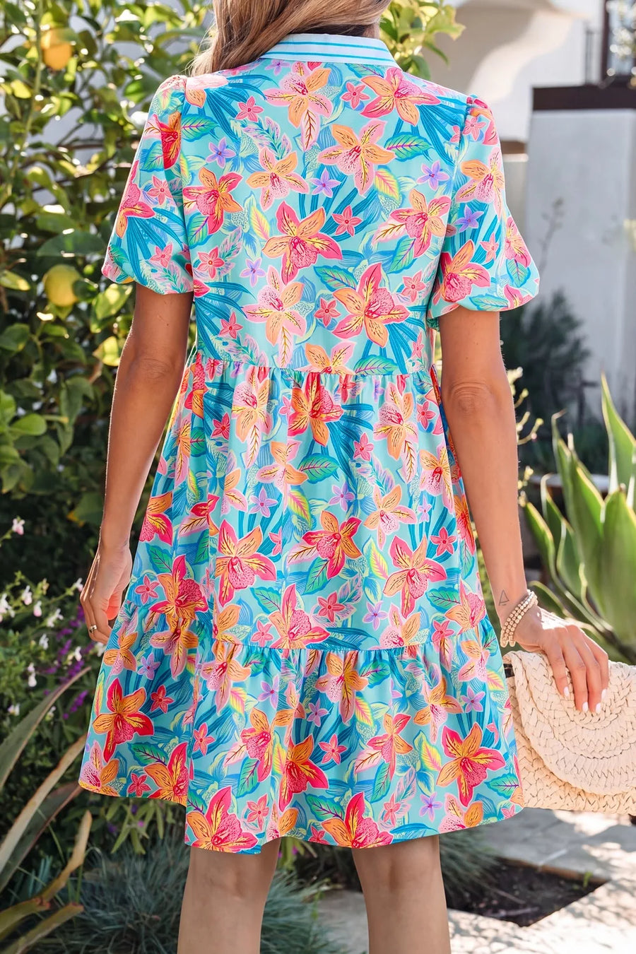 Tropical floral print tiered mini dress with short sleeves and a scalloped hem.