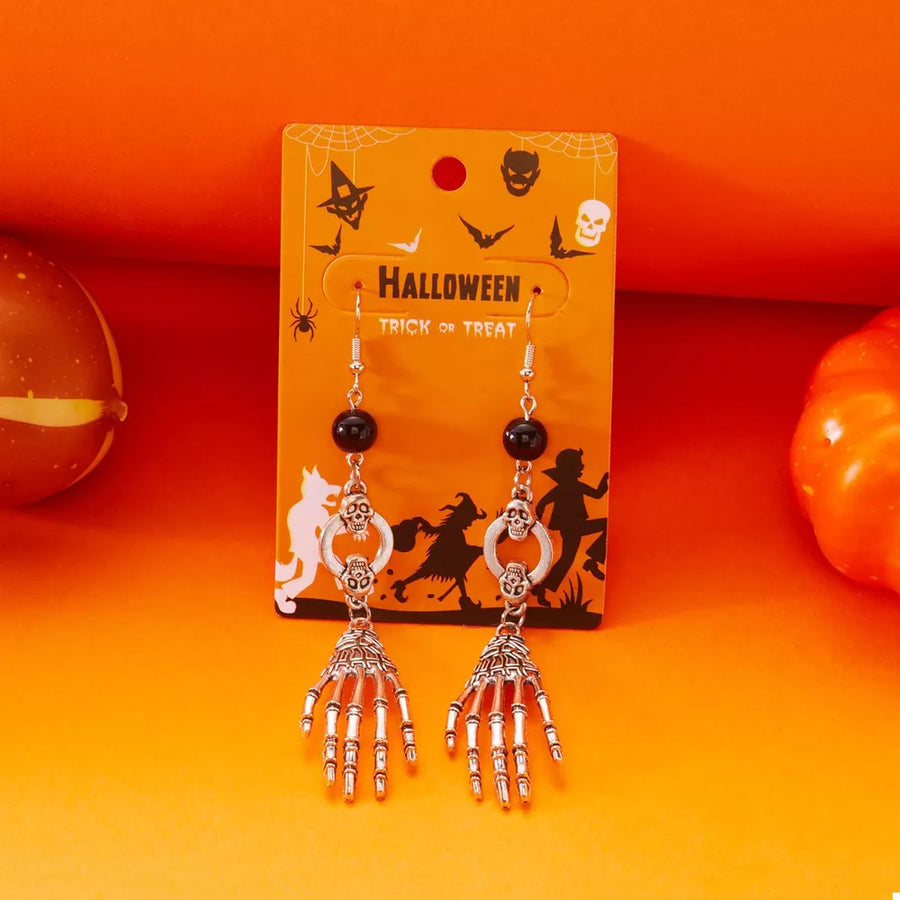 earrings in black with figurative and drop earrings