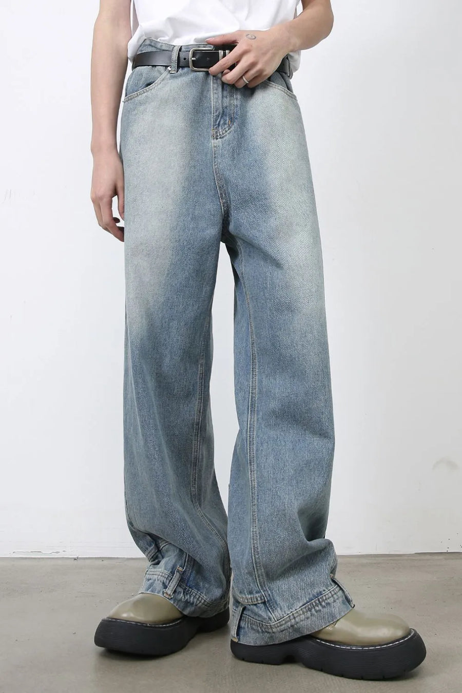 Baggy denim jeans in medium wash with distressed detailing and a relaxed fit.