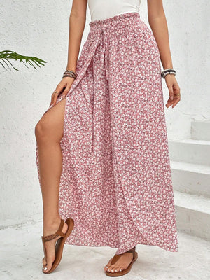 Floral print wrap palazzo pants in blush pink with a high slit and smocked waist.